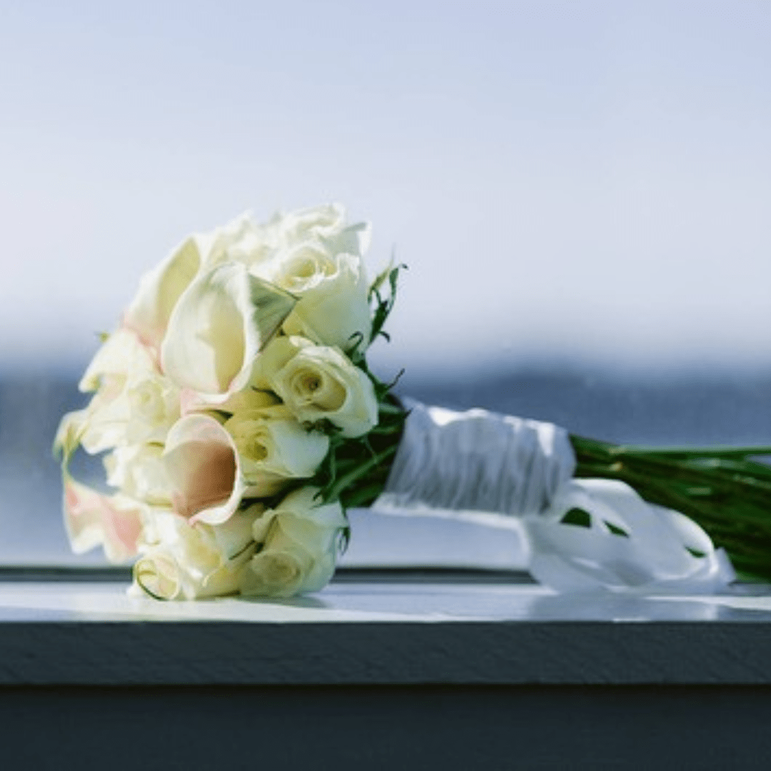 Modern and elegant bridal bouquet featuring white Roses and mini Calla Lilies