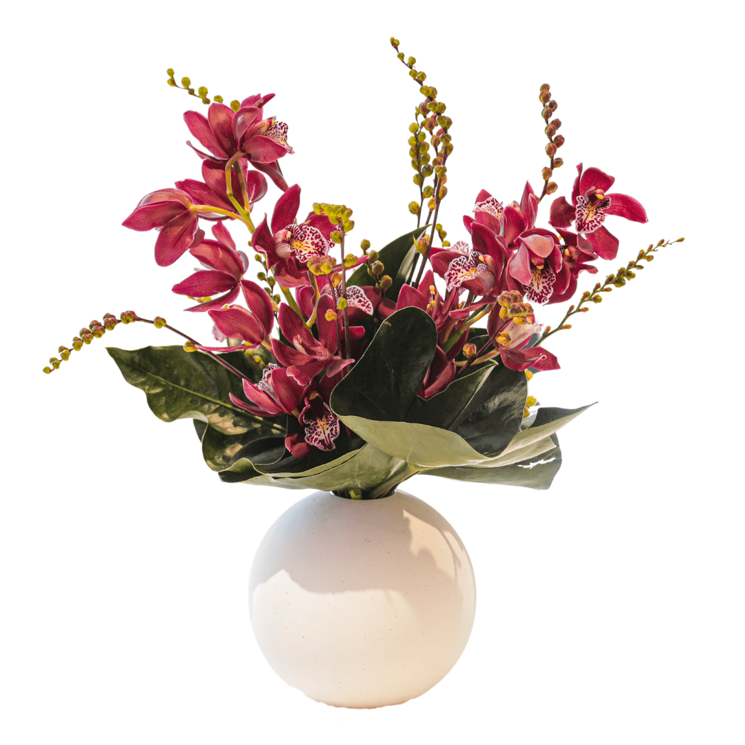 Small modern floral arrangement featuring Orchids