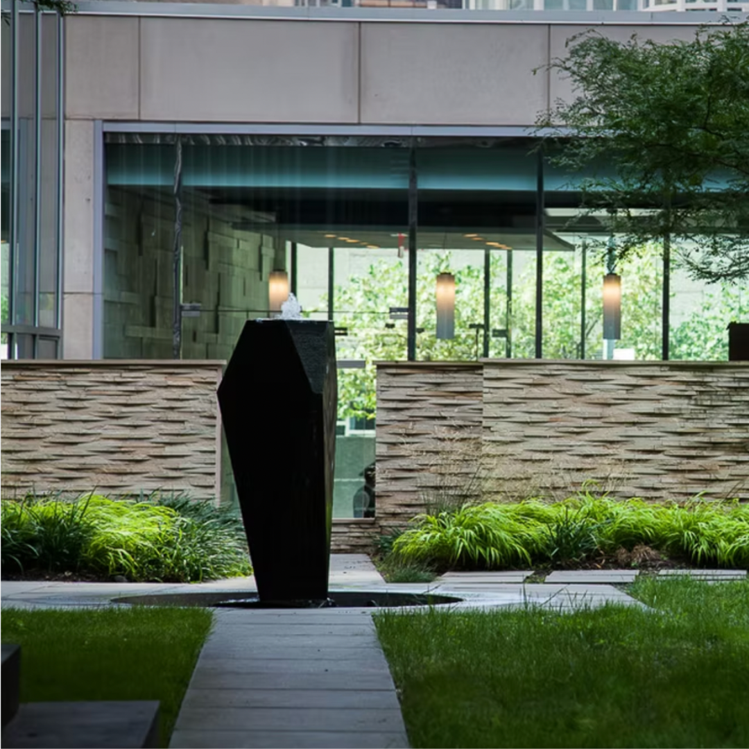 Commercial zen landscaping including various types of grasses and a sculpture