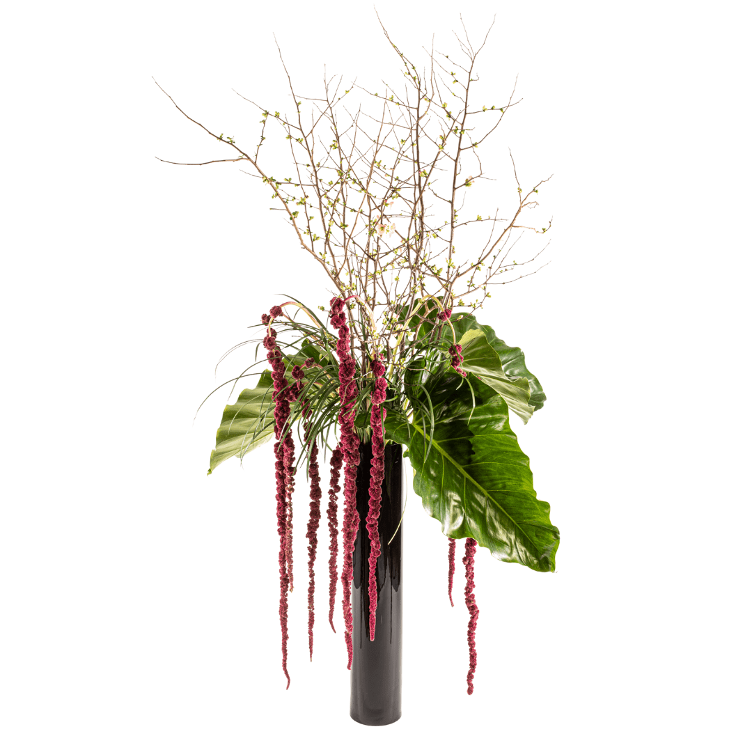 Large and tall statement floral arrangement featuring branches, Monstera leaves and red Anthurium