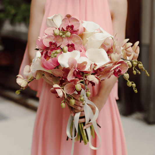 Large and luxurious pink and white bridal bouquet featuring Orchids, Peonies and mini Calla Lilies