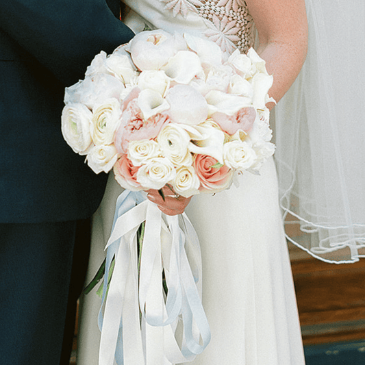 Large white and pink bridal bouquet featuring Roses, Peonies and mini Calla Lilies