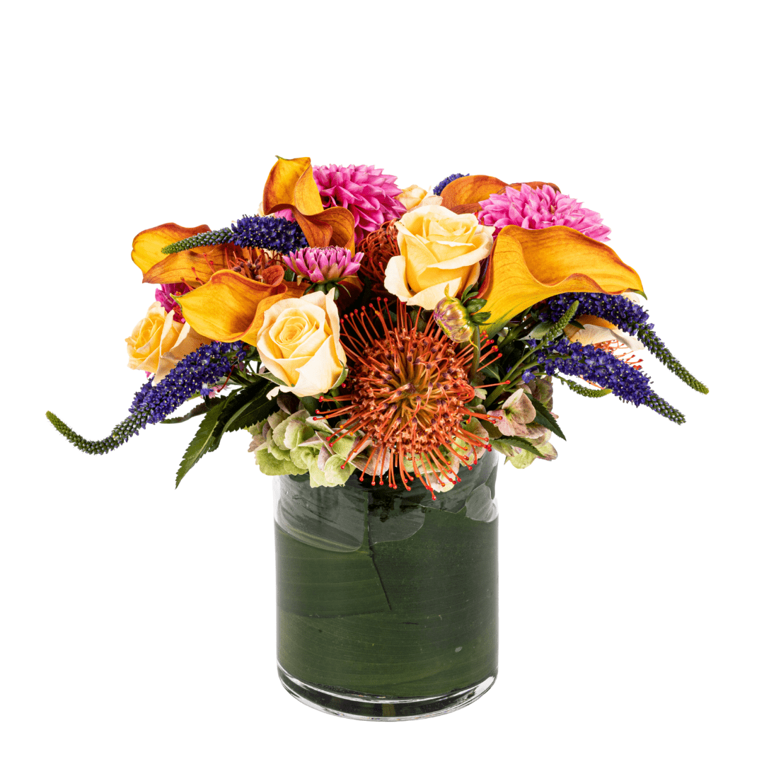 Floral arrangement featuring orange Calla Lilly, Protea and Roses 