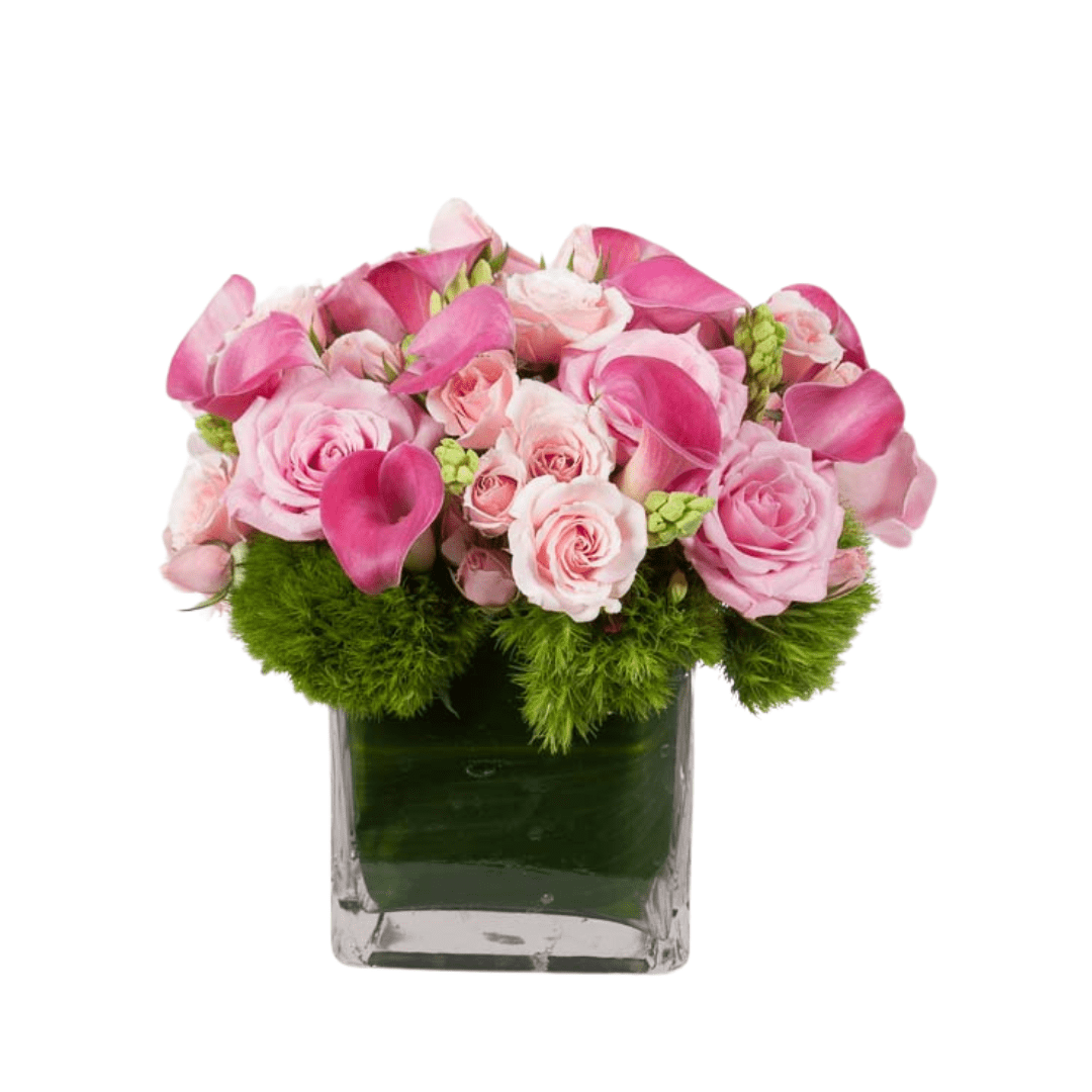 Square pink floral arrangement featuring Roses and mini Calla Lilies